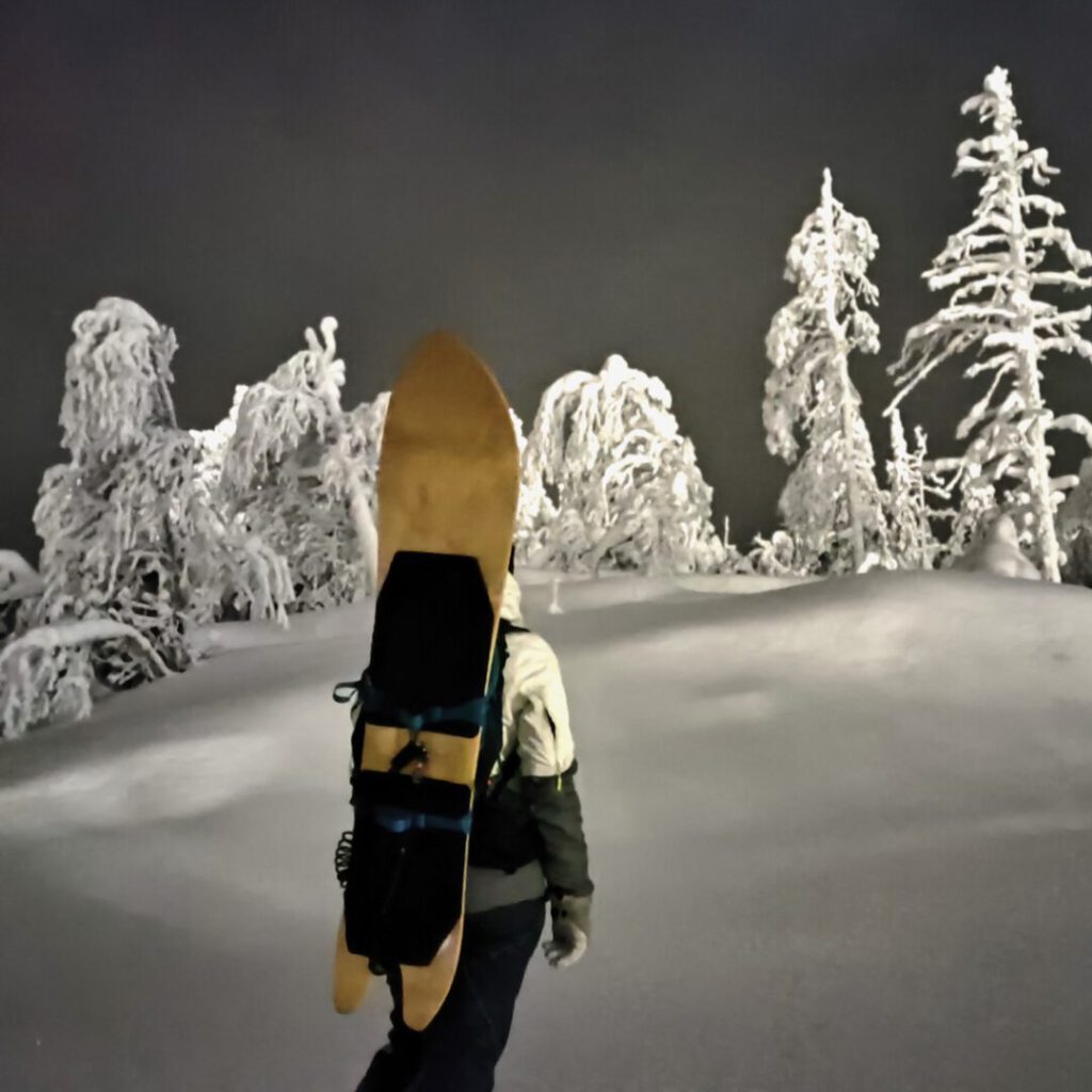 A person climbing up in dark forest