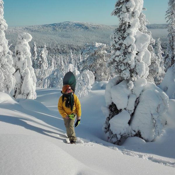 Person hiking uphill on a snowsurf tour